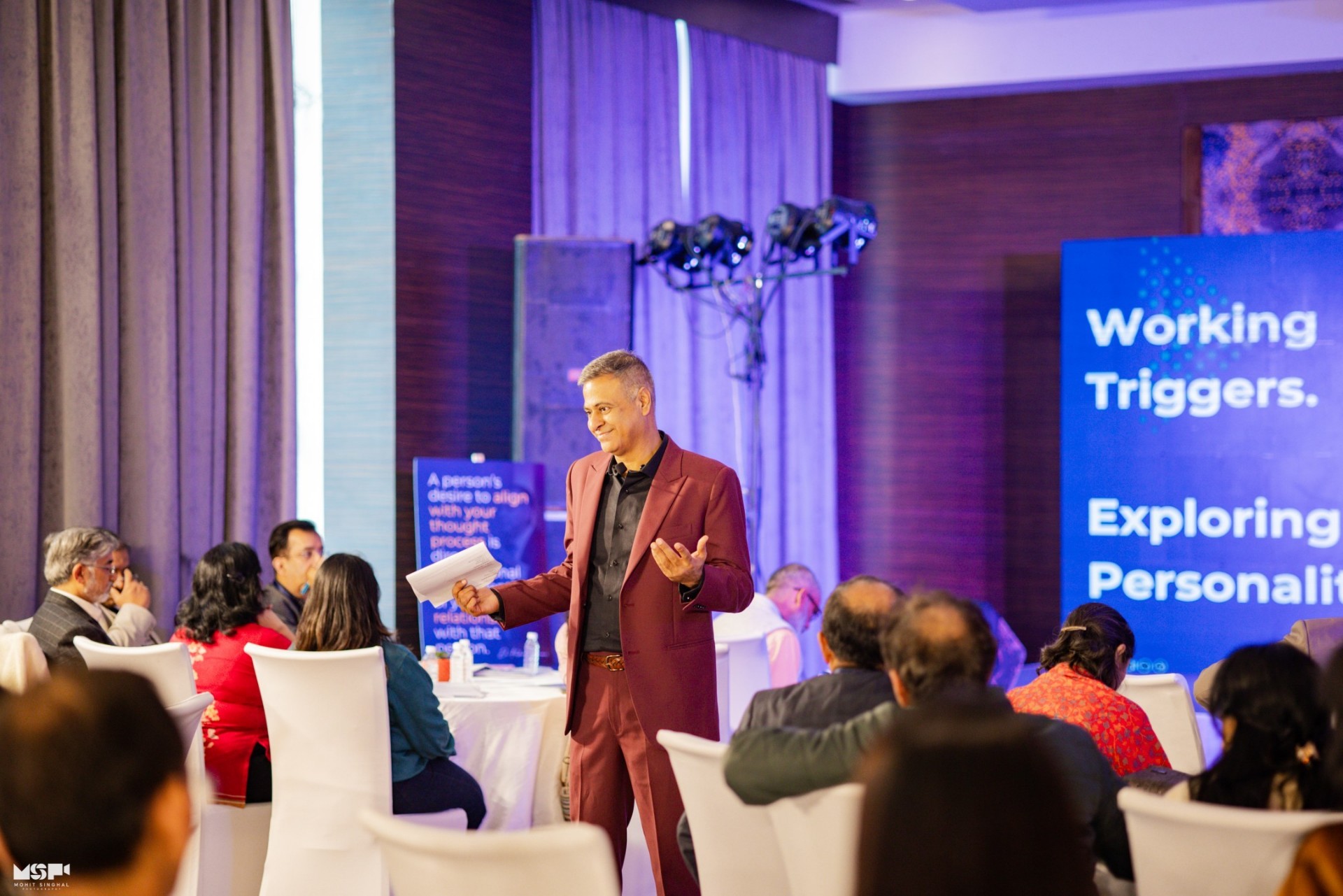 Kishore Chainani on stage delivering a leadership masterclass